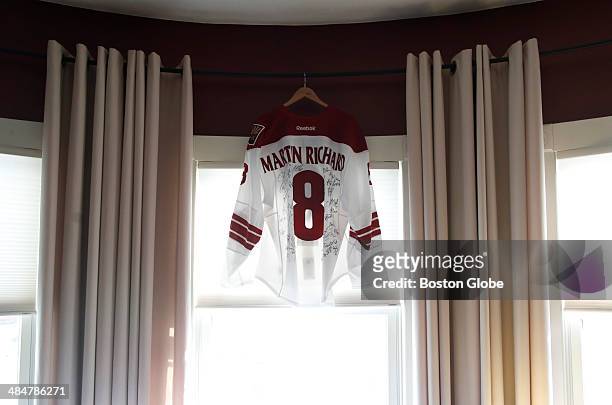Phoenix Coyotes jersey emblazoned with Martin Richards name, worn by defenseman and Boston-area native Keith Yandle, hangs in the window of the...