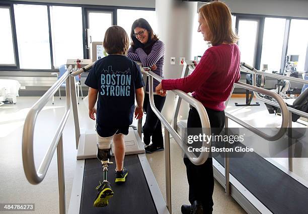 Jane Richard uses a treadmill as she laughs with her mother, Denise Richard, center, and physical rherapist Jean Murby during a check up at Spaulding...