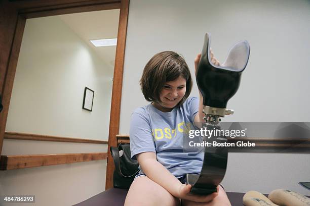 Jane gets her first look at the running blade she is being fitted for at United Prosthetics in Dorchester. Jane lost her lower leg in the Boston...