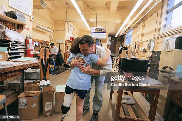 Jane Richard hugs Gary Martino of United Prosthetics who had helped fit and adjust her new running blade at United Prosthetics in Dorchester. Jane...