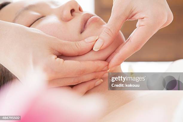 young attractive woman getting spa treatment - body massage japan stock pictures, royalty-free photos & images