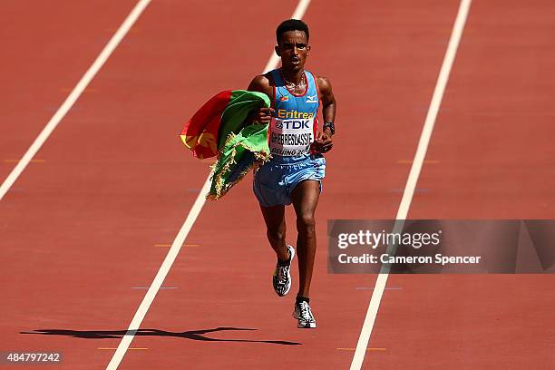Ghirmay Ghebreslassie of Eritrea crosses the line to win gold in the Men's Marathon during day one of the 15th IAAF World Athletics Championships...