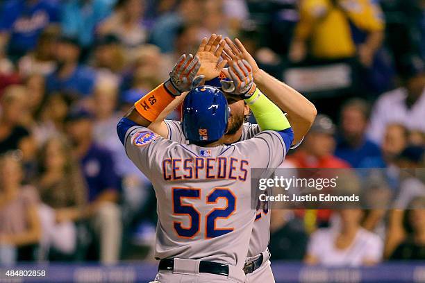 Yoenis Cespedes of the New York Mets is congratulated by Daniel Murphy after hitting his third home run of the game, a three run shot, during the...