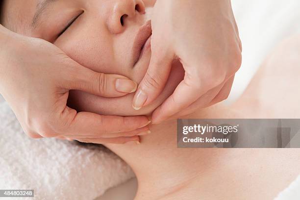 close-up of a young woman getting spa treatment. - body massage japan stock pictures, royalty-free photos & images