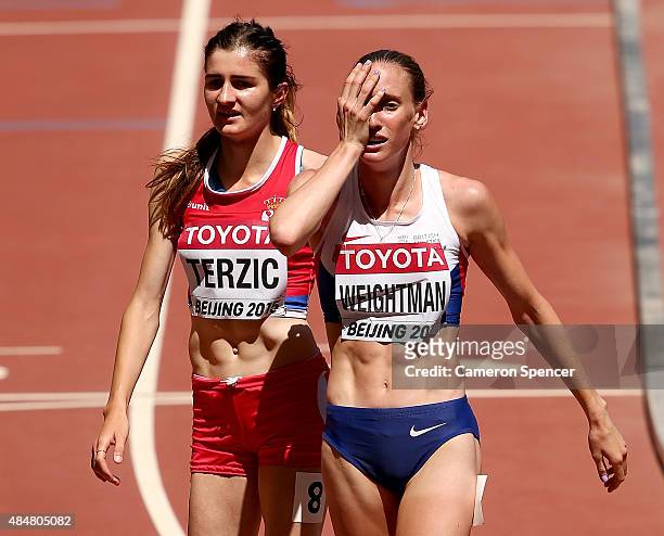 Amela Terzic of Serbia and Laura Weightman of Great Britain react after the Women's 1500 metres heats during day one of the 15th IAAF World Athletics...
