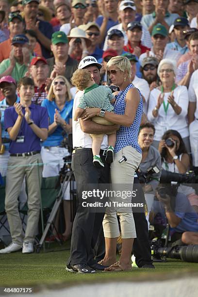 Bubba Watson victorious with his wife Angie Watson and son Caleb Watson at No 18 hole after winning tournament on Sunday at Augusta National....