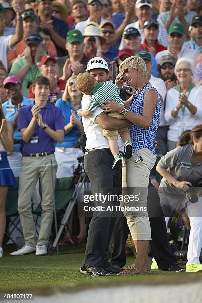 Bubba Watson victorious with his wife Angie Watson and son Caleb Watson at No 18 hole after winning tournament on Sunday at Augusta National....