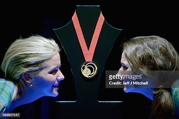 Sarah Bird and Sara Montaghain stand next to the Commonwealth Games Gold medal at the unveiling at Kelvingrove Art Gallery and Museum on April 14,...