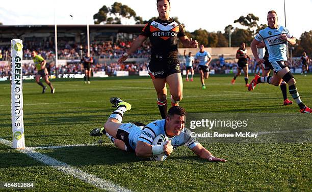 Michael Gordon of the Sharks scores a try during the round 24 NRL match between the Cronulla Sharks and the Wests Tigers at Remondis Stadium on...