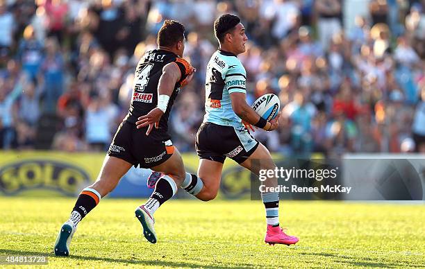 Valentine Holmes of the Sharks makes a break during the round 24 NRL match between the Cronulla Sharks and the Wests Tigers at Remondis Stadium on...