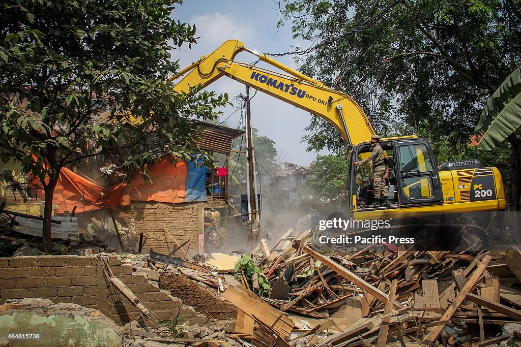 City security personnel use an excavator during eviction of...