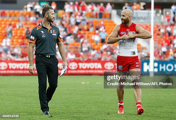 Mark McVeigh, Defensive Coach of the Giants and brother Jarrad McVeigh of the Swans chat after the 2015 AFL round 21 match between the GWS Giants and...