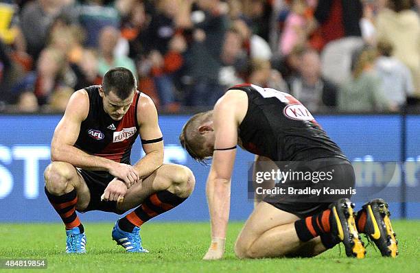 Brent Stanton of the Bombers and team mates are dejected after losing the match after the round 21 AFL match between the Gold Coast Suns and the...