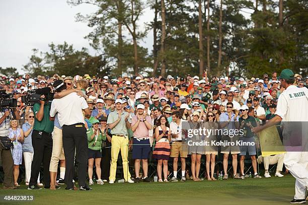 Bubba Watson victorious with his wife Angie Watson and son Caleb Watson at No 18 hole after winning tournament on Sunday at Augusta National....