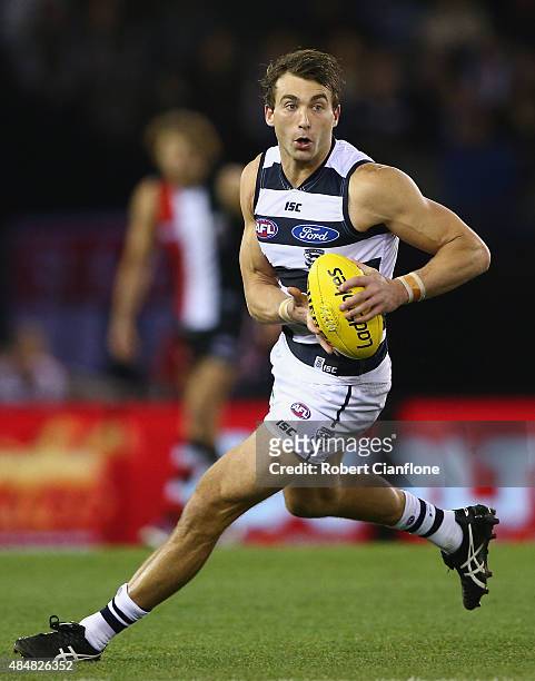 Corey Enright of the Cats runs with the ball during the round 21 AFL match between the St Kilda Saints and the Geelong Cats at Etihad Stadium on...