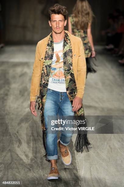 Model walks at the runway during Cavalera show during Sao Paulo Fashion Week Summer 2014/2015 at Parque Candido Portinari on March 31, 2014 in Sao...