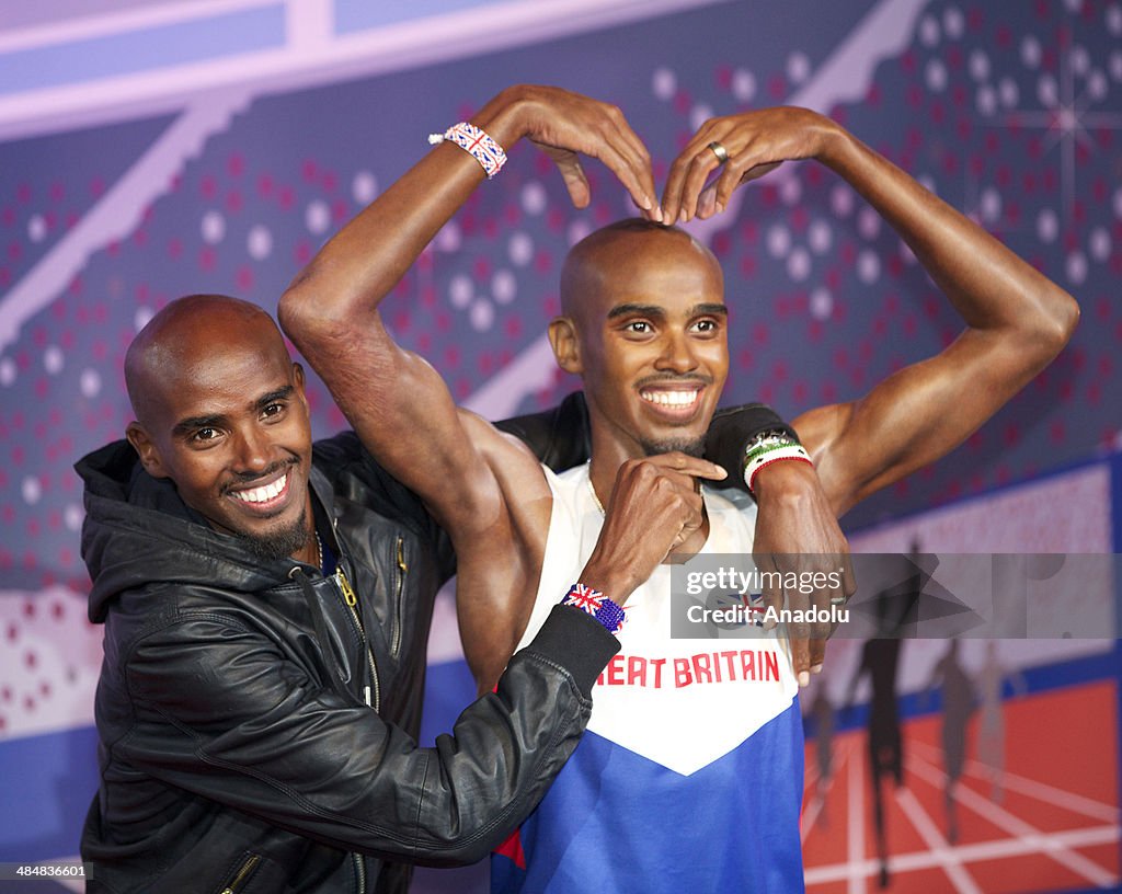 Mo Farah poses with waxwork model of himself