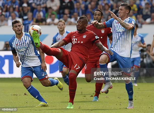 Hoffenheim's midfielder Kevin Volland, Bayern Munich's defender Jerome Boateng and Hoffenheim's Swiss midfielder Steven Zuber vie for the ball during...