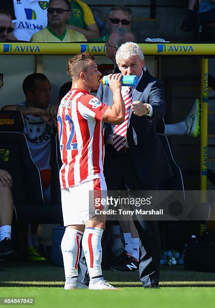 Mark Hughes manager of Stoke City instructs Xherdan Shaqiri during the Barclays Premier League match between Norwich City and Stoke City at Carrow...