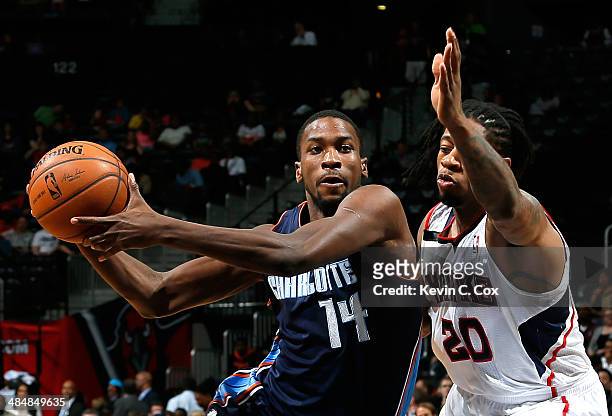 Michael Kidd-Gilchrist of the Charlotte Bobcats drives against Cartier Martin of the Atlanta Hawks at Philips Arena on April 14, 2014 in Atlanta,...
