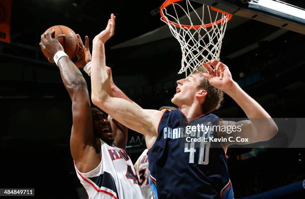 Elton Brand of the Atlanta Hawks grabs a rebound against Cody Zeller of the Charlotte Bobcats at Philips Arena on April 14, 2014 in Atlanta, Georgia....