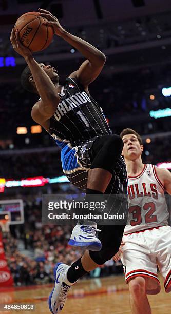 Doron Lamb of the Orlando Magic shoots past Jimmer Fredette of the Chicago Bulls at the United Center on April 14, 2014 in Chicago, Illinois. NOTE TO...