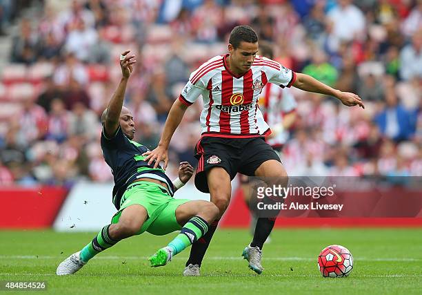 Jack Rodwell of Sunderland is tackled by Andre Ayew of Swansea City during the Barclays Premier League match between Sunderland and Swansea City at...