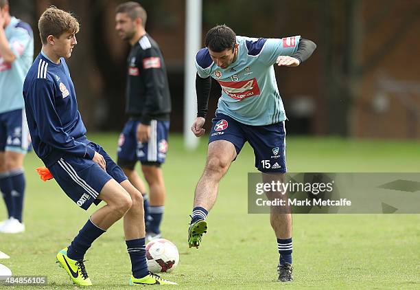 Terry McFlynn is tackled during a Sydney FC A-League training session at Macquarie Uni on April 15, 2014 in Sydney, Australia.