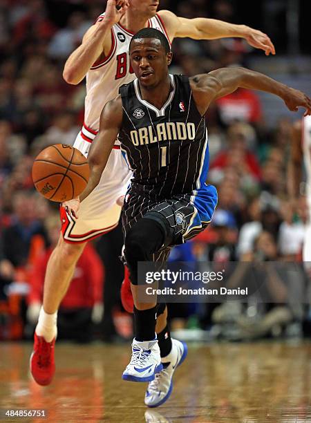 Doron Lamb of the Orlando Magic chases down a loose ball in front of Mike Dunleavy of the Chicago Bulls at the United Center on April 14, 2014 in...