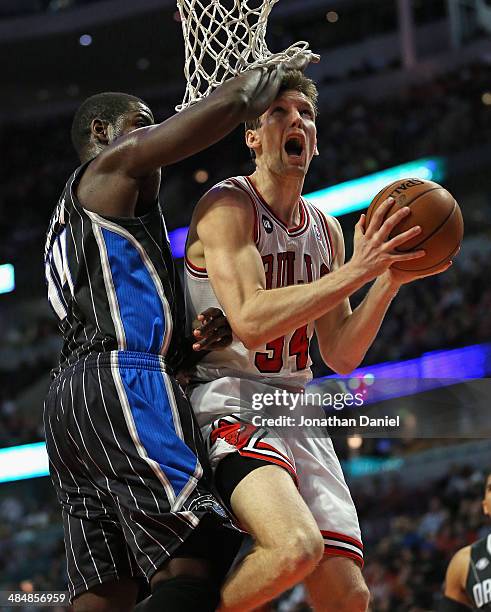 Mike Dunleavy of the Chicago Bulls is fouled by Andrew Nicholson of the Orlando Magic at the United Center on April 14, 2014 in Chicago, Illinois....