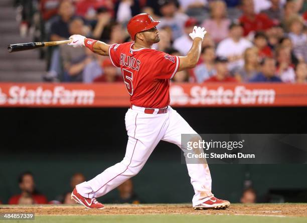Albert Pujols of the Los Angeles Angels of Anaheim hits a solo home run in the third inning against the Oakland Athletics at Angel Stadium of Anaheim...
