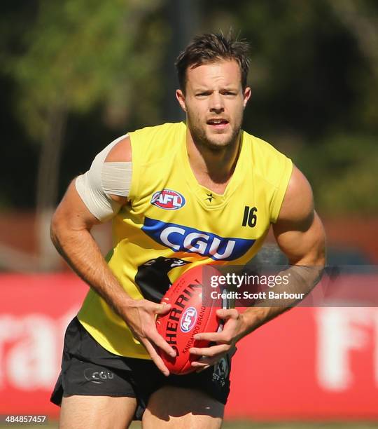 Nathan Brown of the Magpies runs with the ball during a Collingwood Magpies AFL training session at Olympic Park on April 15, 2014 in Melbourne,...