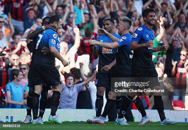 Marc Pugh of Bournemouth celebrates scoring his team's third goal from the penalty spot with his team mates during the Barclays Premier League match...