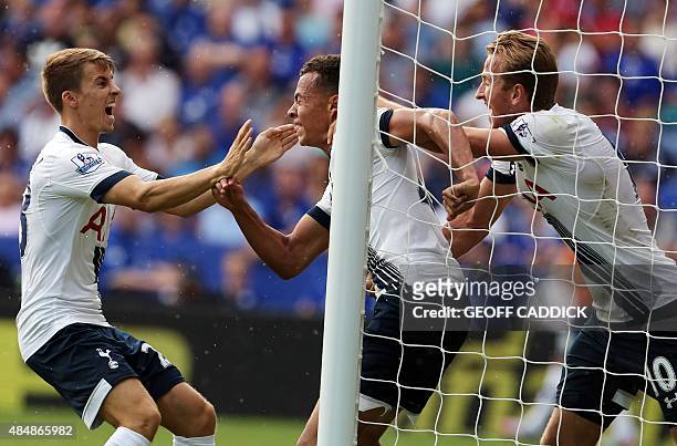 Tottenham Hotspur's midfielder Dele Alli celebrates scoring with his Tottenham Hotspur team mates Tom Carroll and Harry Kane during the English...