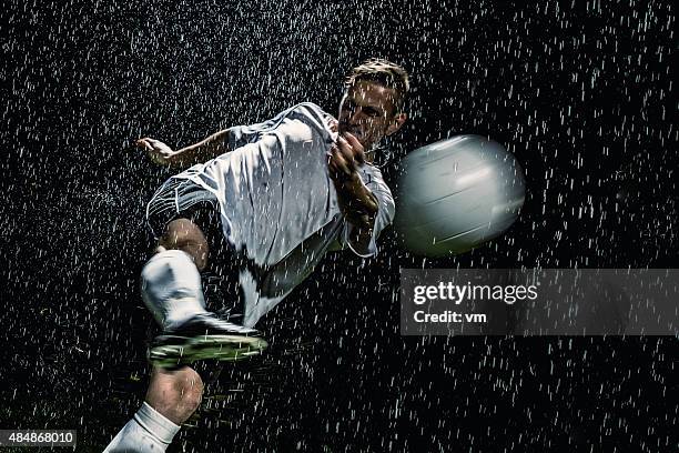 soccer player in action - soccer boot stock pictures, royalty-free photos & images