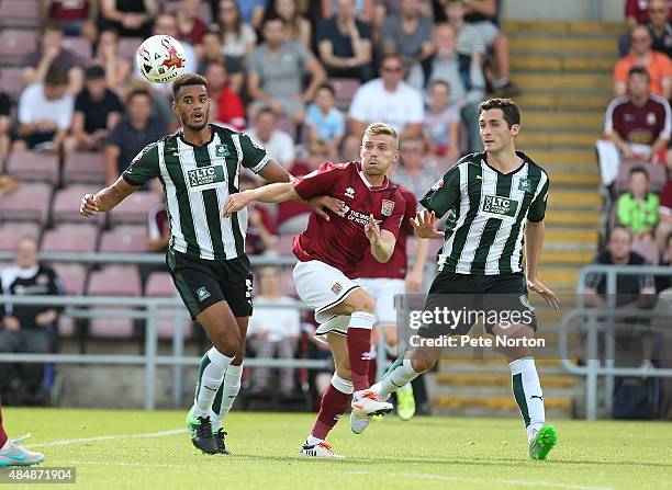 Alfie Potter of Northampton Town challenges for the ball with Curtis Nelson and Carl McHugh of Plymouth Argyle during the Sky Bet League Two match...