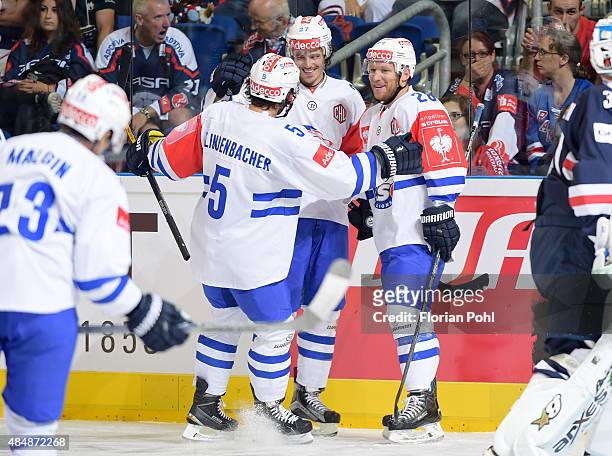 Severin Blindenbacher, Roman Wick and Ryan Keller of ZSC Lions Zuerich fight for the puck during the game between Eisbaeren Berlin and ZSC Lions...