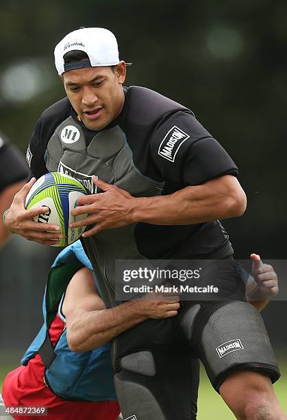 Israel Folau is tackled during a Waratahs Super Rugby training session at Moore Park on April 15, 2014 in Sydney, Australia.