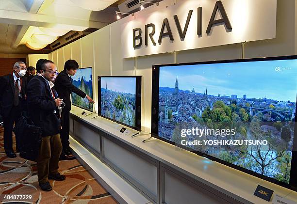 Journalists look at Japanese electronics maker Sony's new 4K television set line up at a press preview in Tokyo on April 15, 2014. Sony controlled...