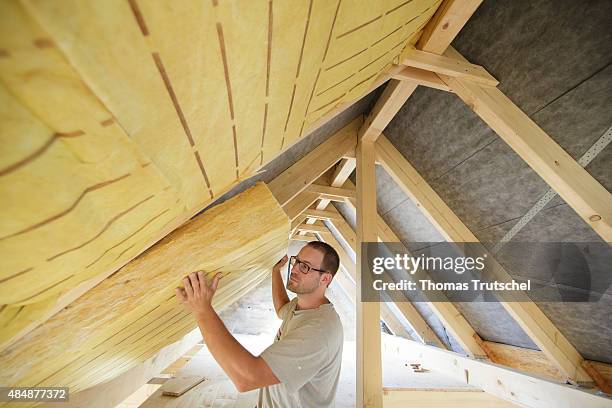 Berlin, Germany Craftsman insulating the interior room of a house under the roof. On August 21, 2015 in Berlin, Germany.