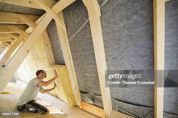 Berlin, Germany Craftsman insulating the interior room of a house under the roof. On August 21, 2015 in Berlin, Germany.