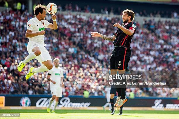 Markus Feulner of Augsburg jumps for a header with Marco Russ of Frankfurt during the Bundesliga match between Eintracht Frankfurt and FC Augsburg at...