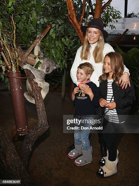 Sophie Falkiner poses alongside a koala and her children Jack Thomas and Isabella Thomas at the EMU Australia Celebrity Children's event at Sydney...