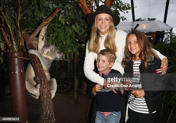 Sophie Falkiner poses alongside a koala and her children Jack Thomas and Isabella Thomas at the EMU Australia Celebrity Children's event at Sydney...