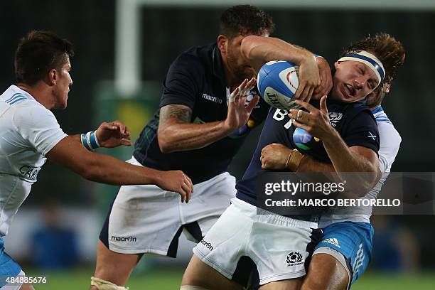 Scotland's Hamish Watson is tackled by Italian players during the Rugby World Cup Test match Italy Vs Scotland on August 22, 2015 at the "Olympic...