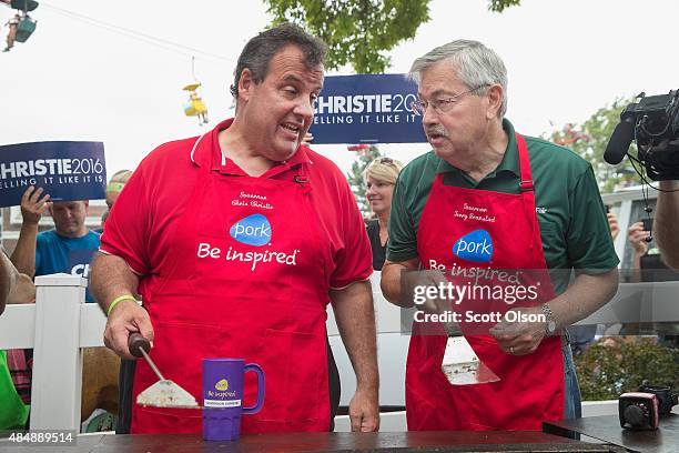 Republican presidential candidate New Jersey Governor Chris Christie and Iowa Governor Terry Branstad help to cook pork at the Iowa Pork Producers...