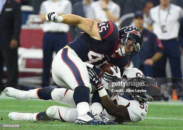 Denver Broncos middle linebacker Steven Johnson hauls down Houston Texans fullback Jay Prosch after a short gain during the first quarter August 22,...