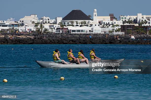 Tourists ride on a raft at at Playa Blanca beach on April 13, 2014 in Lanzarote, Spain. Lanzarote, where British Prime Minister David Cameron and his...