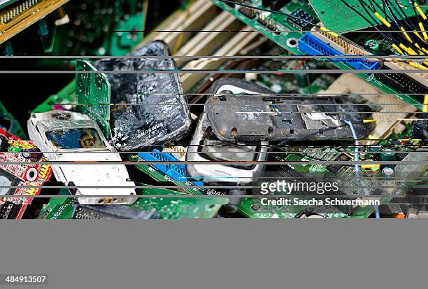 Old mobile phones lie between electronic components including circuit boards sit in a pile ahead of recycling at Aurubis AG metal refinery on...