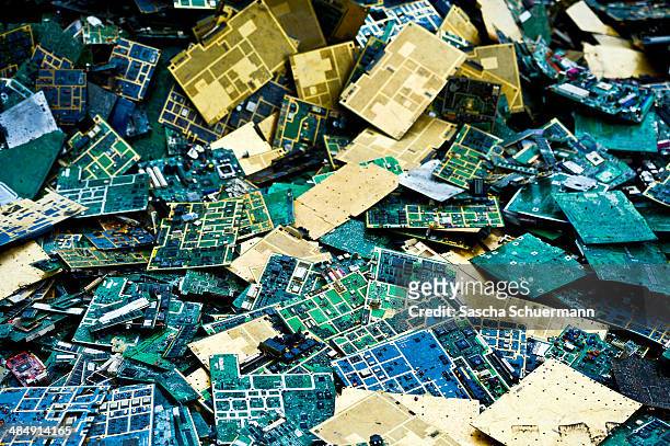 Electronic components including circuit boards sit in a pile before being melted down at the Aurubis recycling smelter on April 14, 2014 in Luenen,...